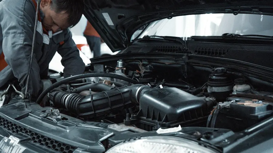 Technician inspecting a car engine